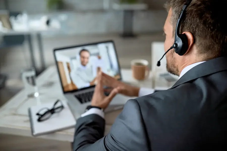 Closeup of entrepreneur using laptop while having online business meeting in the office