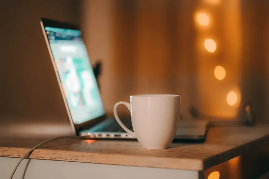 Coffee cup on table with laptop
