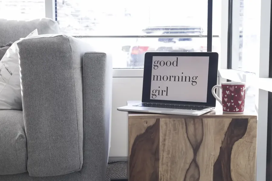 Laptop with coffee cup on table